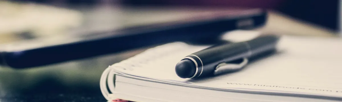 Black twist pen on notebook