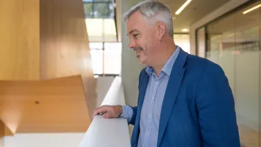 Portrait of a man standing inside a building