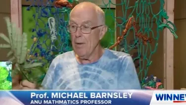 Michael Barnsley on the news holding a fern leaf