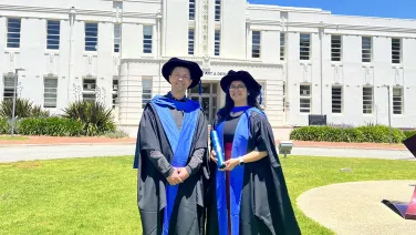 Two people standing in front of a building